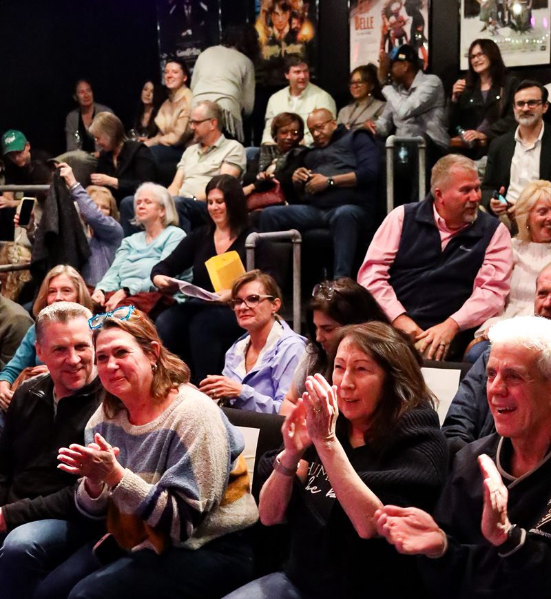 A packed audience laughing and applauding during a Rick Silver mentalism show